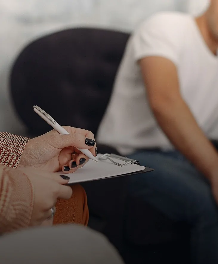 Therapist taking notes during a session