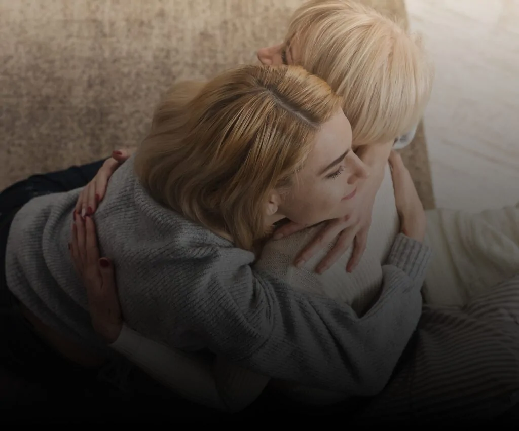 Mother and adult daughter embracing