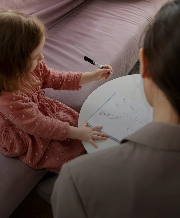 Girl drawing during a child therapy session