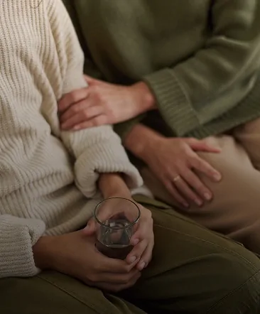 Couple holding hands during a therapy session