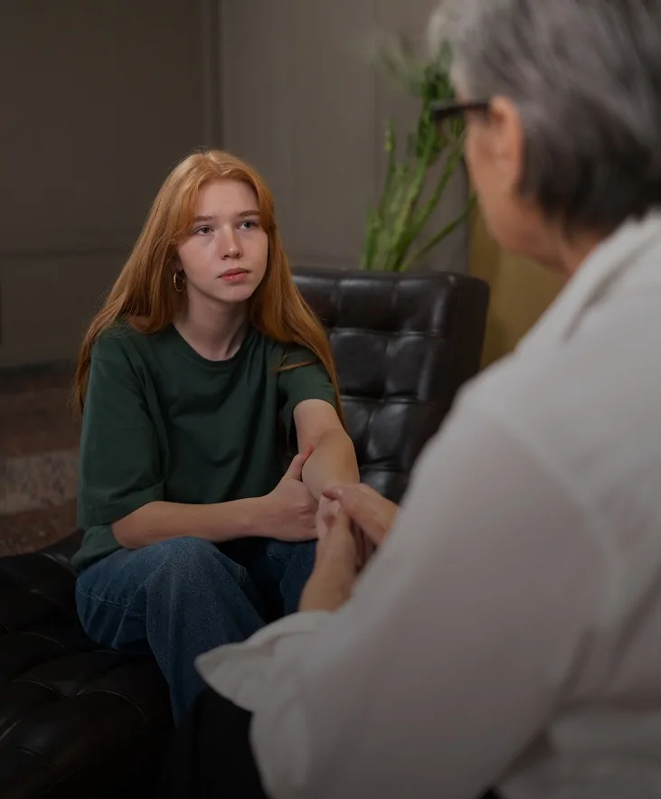 Teenage girl talking with a therapist